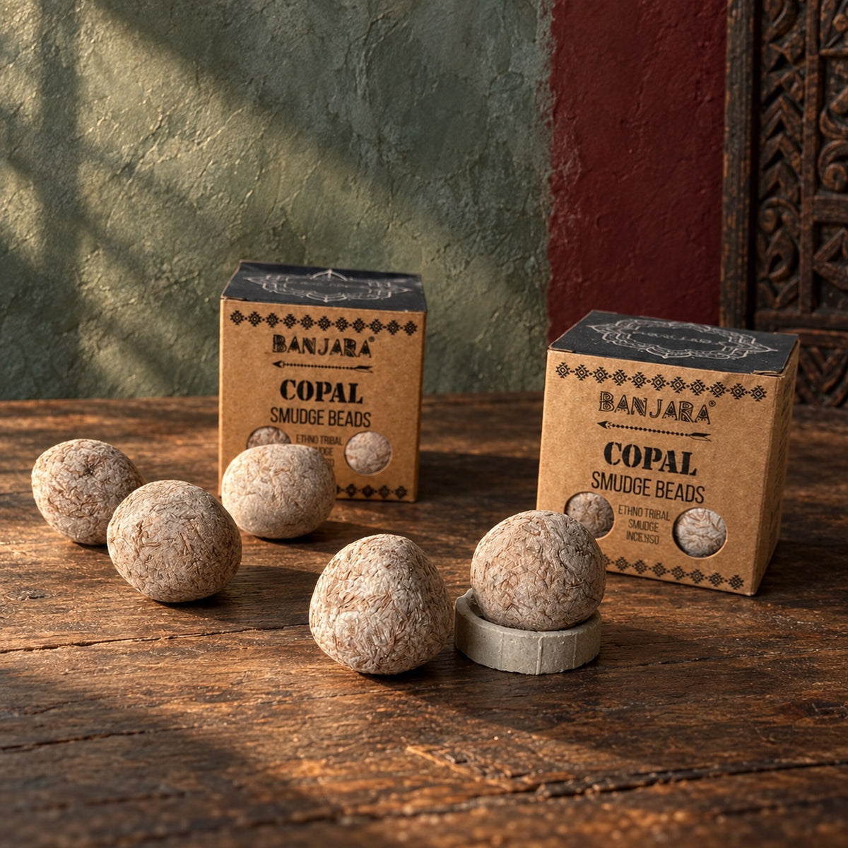 Banjara Copal Smudge Beads with pressed incense beads and packaging on a wooden table.