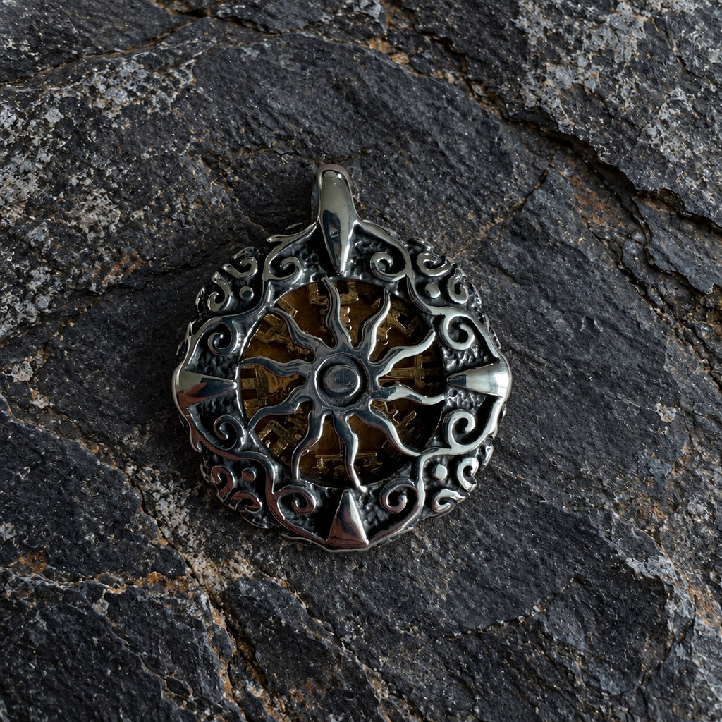 Reverse side of Nordic pendant featuring a silver-tone sun wheel design with ornamental circular frame.