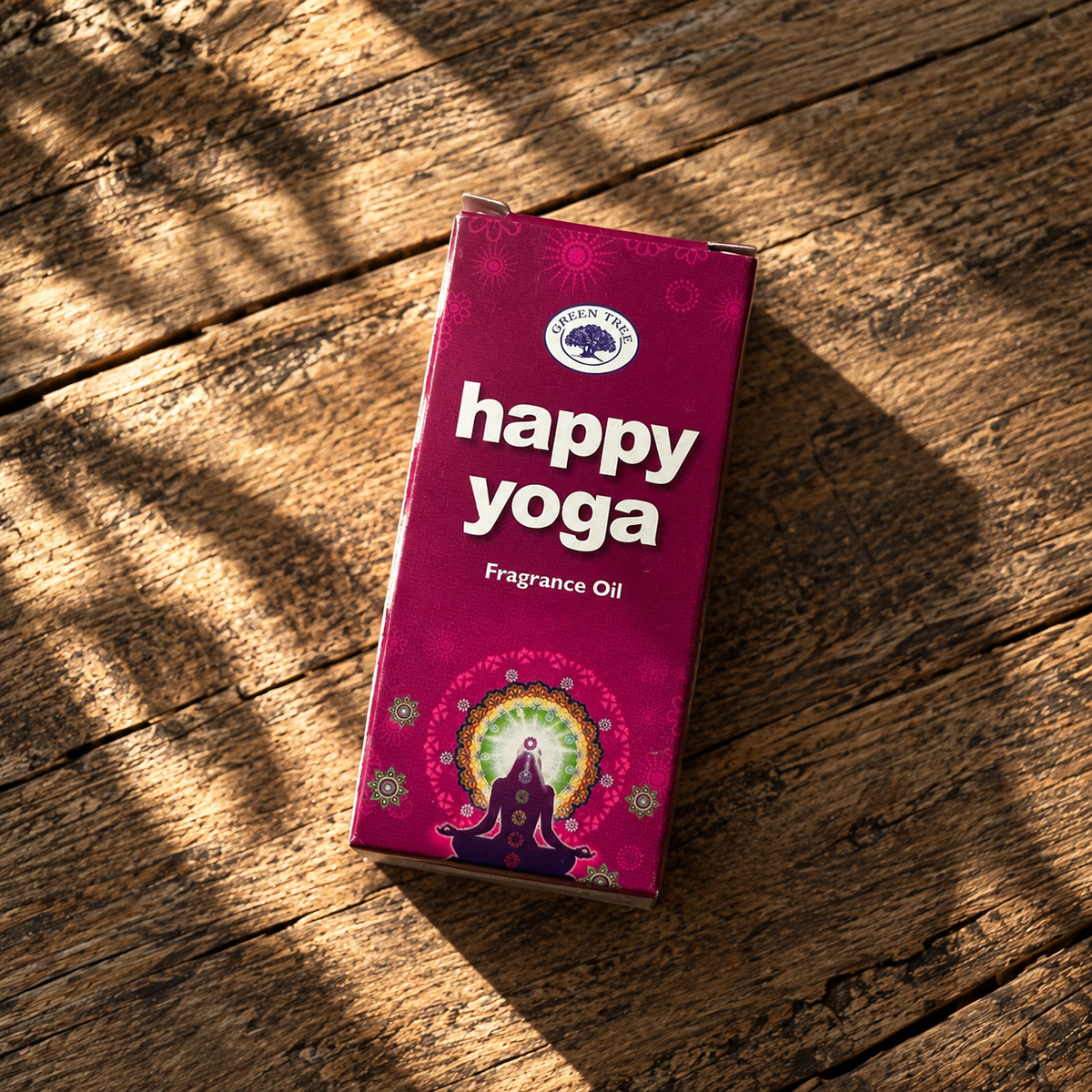 Green Tree Happy Yoga Fragrance Oil box displayed on a natural wooden surface.