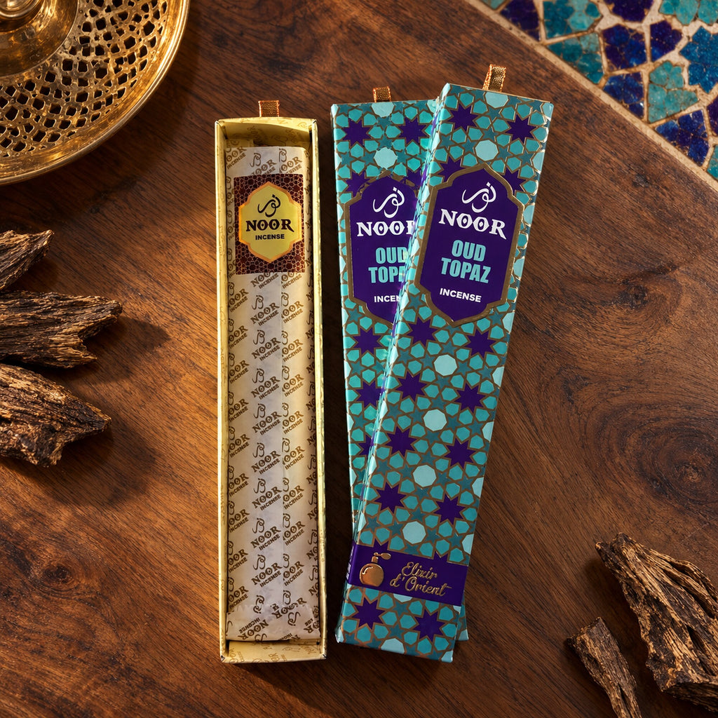 Open Noor Oud Topaz incense presentation box showing the wrapped 15 g incense pack inside.