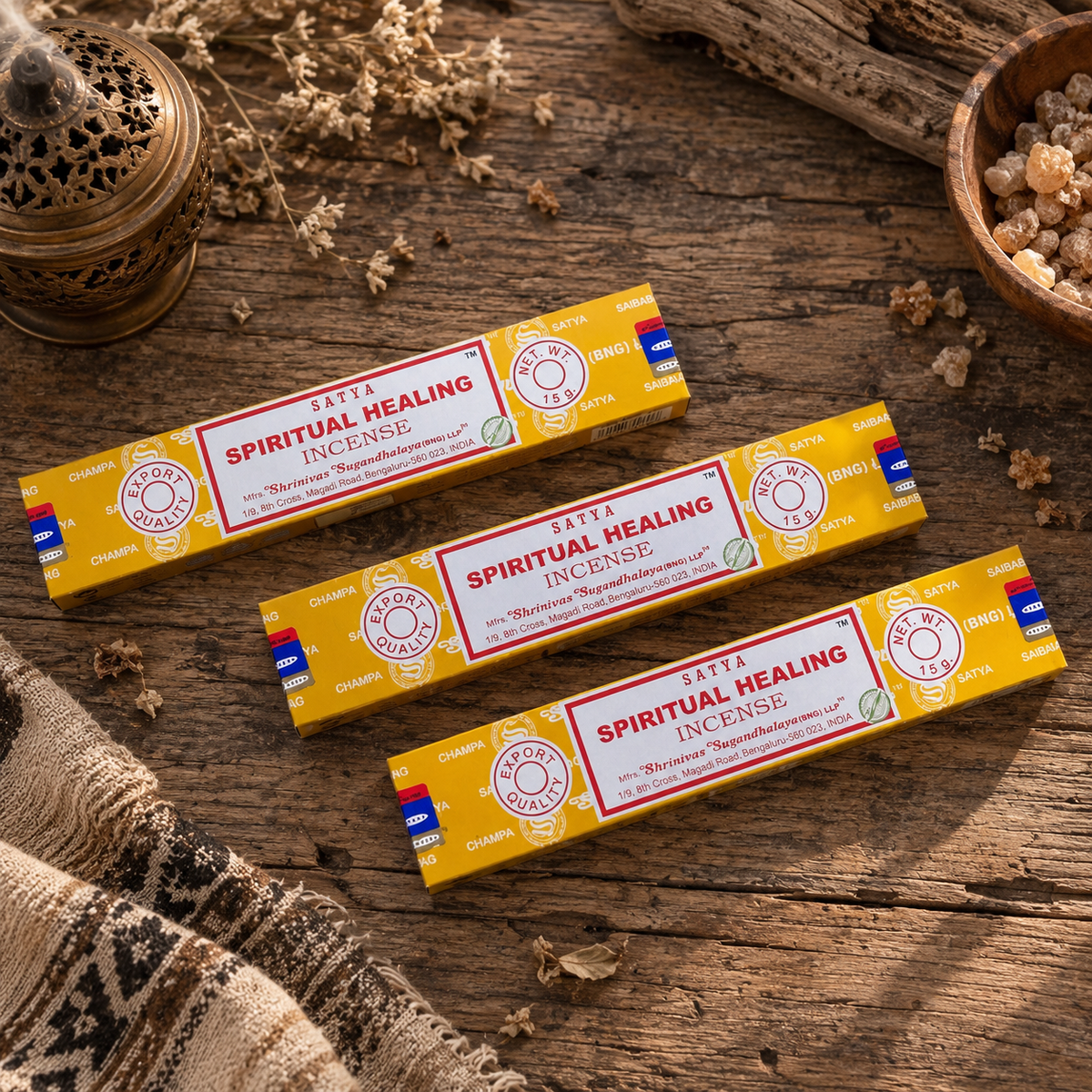 Satya Spiritual Healing Incense Sticks 15g displayed on rustic wooden surface with dried botanicals and incense accessories.
