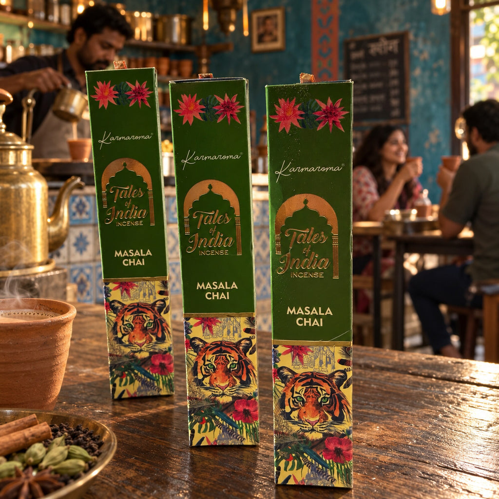 Tales of India Masala Chai incense boxes displayed in an Indian chai café setting with brass teaware and spices.